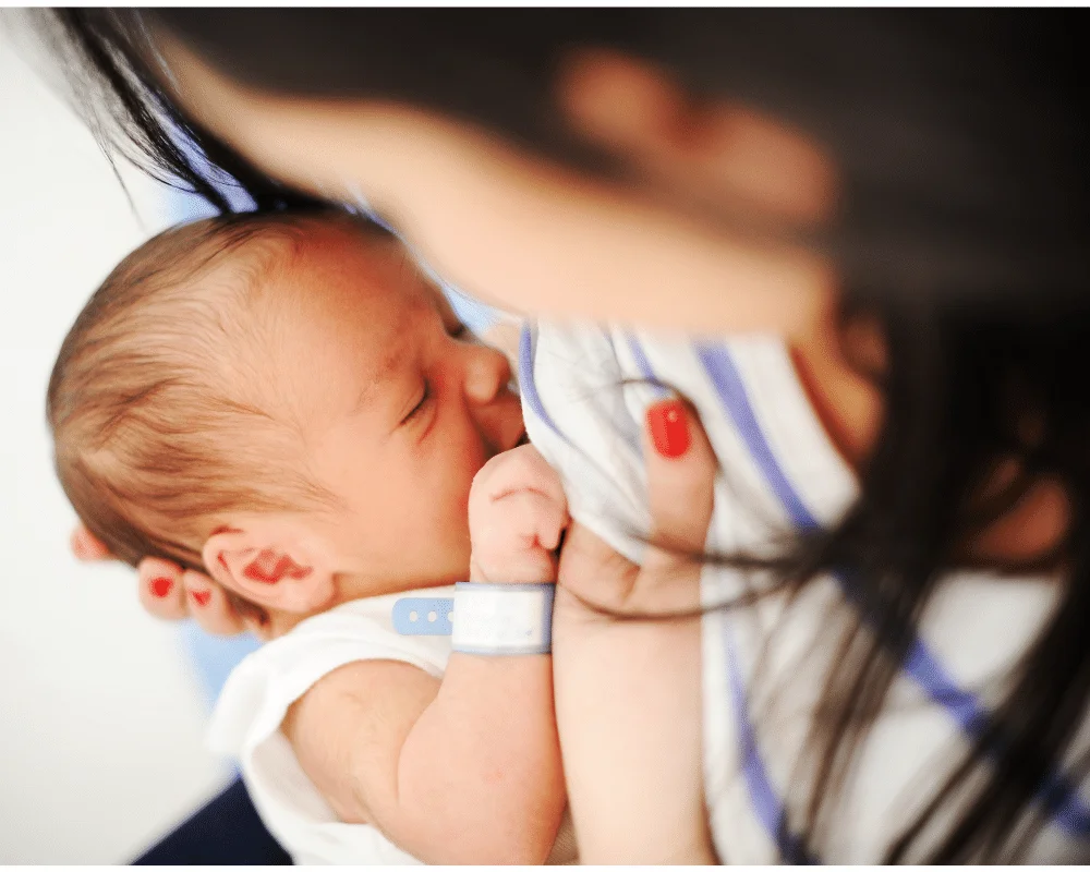 mom looking down at baby while breastfeeding