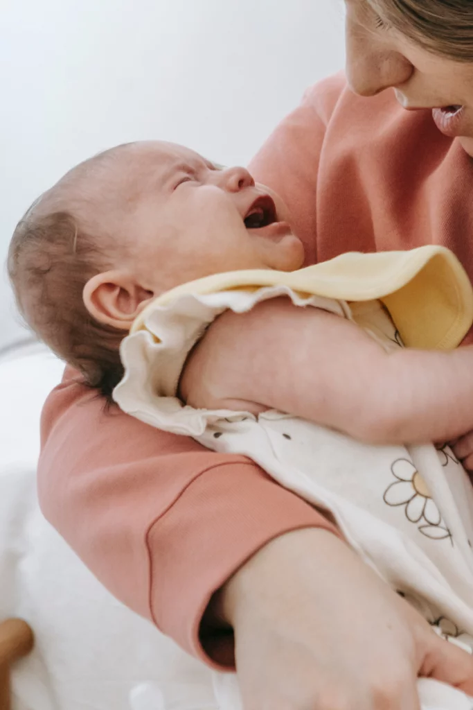 close up of a mom holding a tiny crying baby trying to calm her