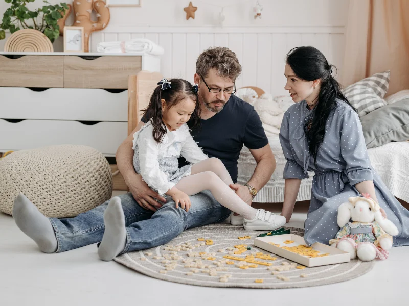 family sitting on the floor playing a game