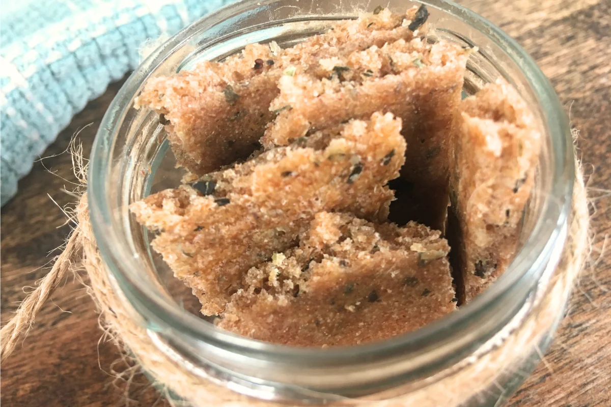 spelt sourdough discard crackers in mason jar with burlap string around it