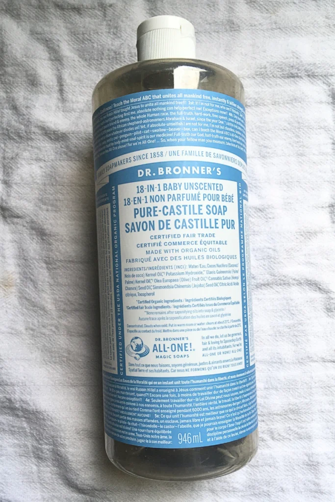 Dr. Bronner's Castile soap laying on a white tea towel