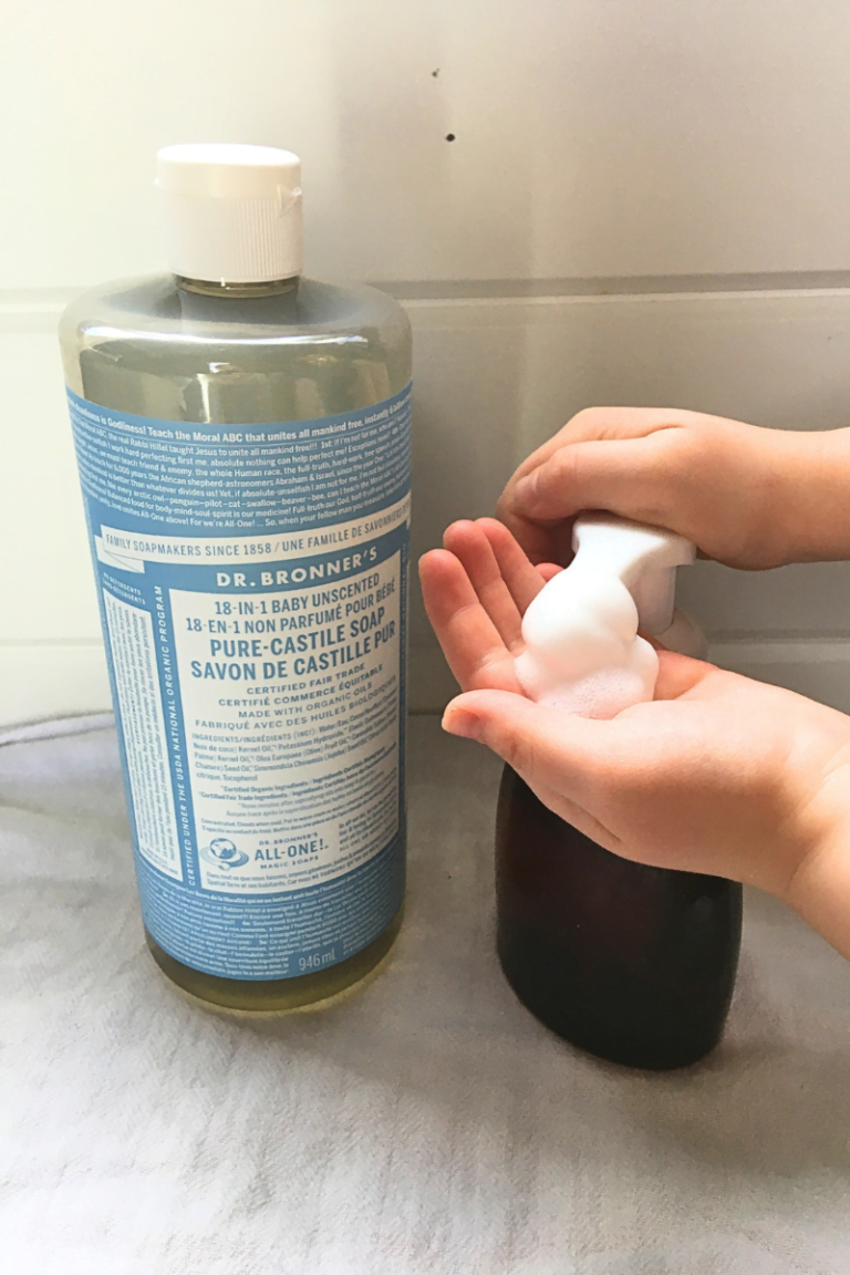 Dr. Bonner's Castile soap next to an amber foaming soap pump with a child's hands pumping soap.