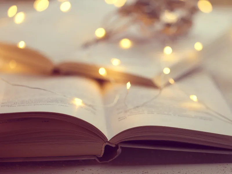 open books with lights blurred in the background