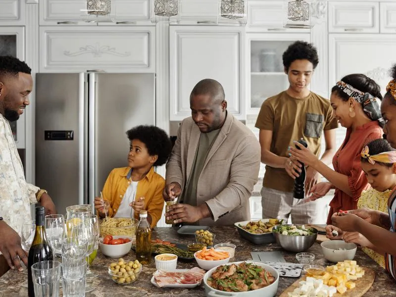 people enjoying a meal together in a kitchen