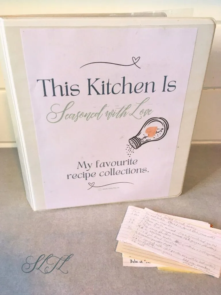 recipe binder standing up with stack of recipe cards beside it