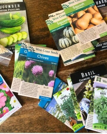 piles of seed packages on a wooden table