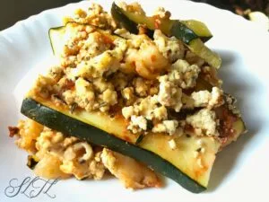 zucchini lasagna slice on white plate with tofu ricotta