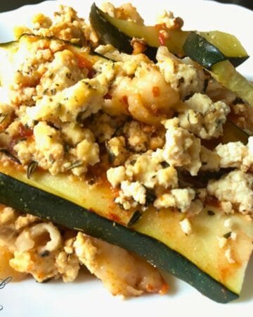 zucchini lasagna slice on white plate with tofu ricotta