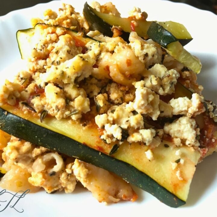 zucchini lasagna slice on white plate with tofu ricotta